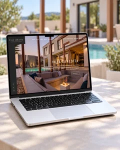 Web stranica Ville Carlotta prikazana na laptopu s modernom vilom u pozadini.